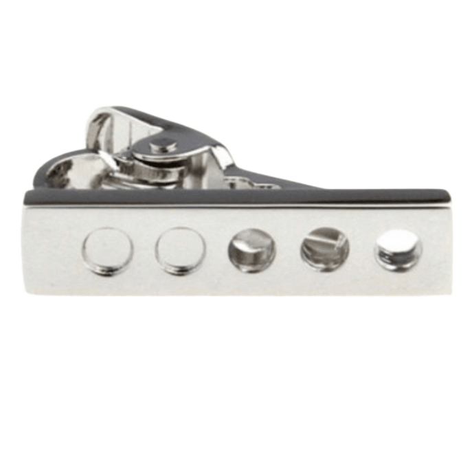 a silver tie clip with cut out circle design 