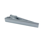 silver tie clip with a diagonal imprint over it